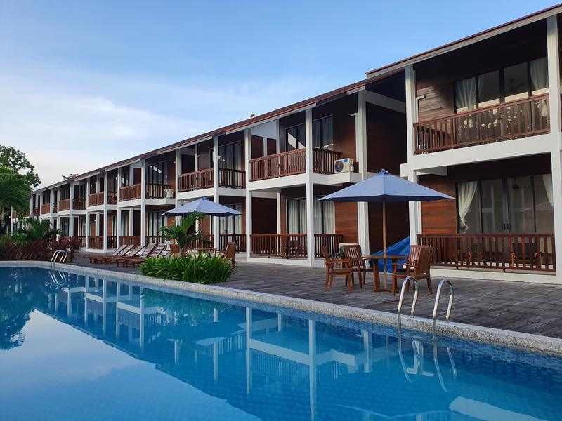 Two-storey villa building with balconies beside a swimming pool at Borneo Divers Mabul Resort (placeholder, to recheck when the photo is replaced)